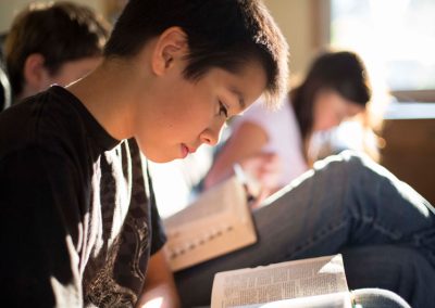 resized image of a young boy reading the scriptures